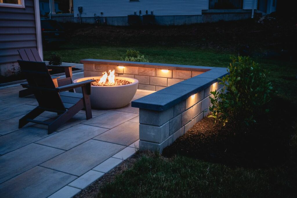 Stone patio with fire pit at night